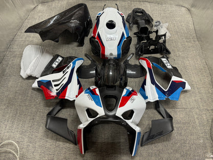 A set of BMW M1000RR carbon fiber fairings in white livery