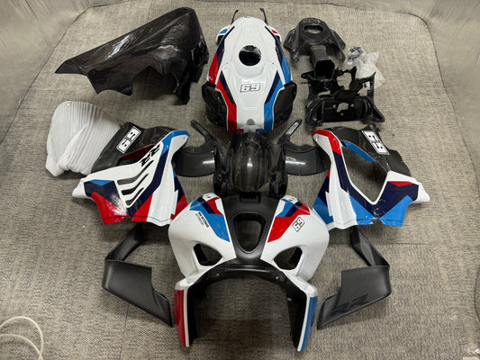 A set of BMW M1000RR carbon fiber fairings in white livery